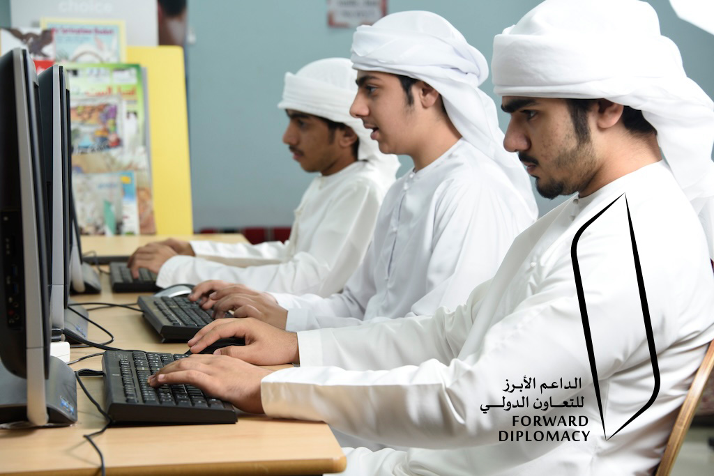 An image of three boys using a computer